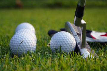 Wall Mural - Golf equipment on green grass.