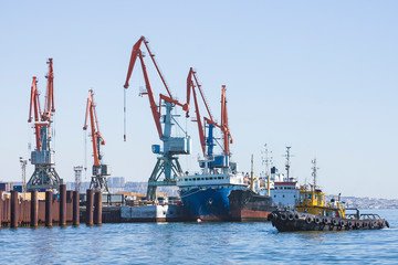  Large port cranes against a blue sky. Close-up of the construction elements of the crane.