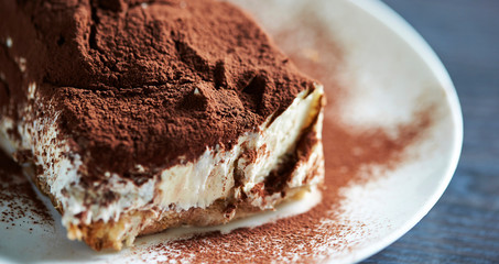 Poster - Tiramisu cake on white plate