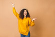 © denis_vermenko - Happy winner. Portrait of cheerful positive girl jumping in the air looking at camera isolated on beige background. Life people energy concept.