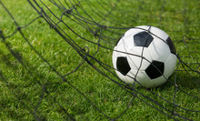 Goal Concept As A Soccer Ball Enters The Gate And Hits The Net. Football Championship Background, Spring Outdoors Tournaments. Healthy Sports Activity And Games.
