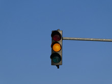 Yellow Color On The Traffic Light With Blue Sky In Background