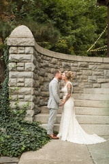 Wall Mural - Bride and groom kissing at bottom of outdoor staircase