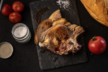 Wall Mural - piece of entrecote on slate, with black background