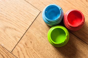 colored ink bottles on a wooden floor 