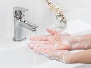 Wall Mural - Hygiene concept hand detail. Close up. Woman cleaning hands, washing hands with soap bubbles