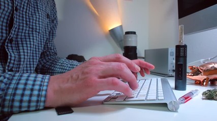 Poster - A businessman is sitting at a desk typing text on a keyboard. The concept of electronic information transfer.