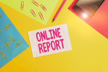 Fototapete - Handwriting text writing Online Report. Conceptual photo to give a description of something or information about it Paper sheets pencil clips smartphone squared notebook colored background