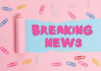 Poster - Word writing text Breaking News. Business photo showcasing Newly received info about an event and currently occurring Paper clip and torn cardboard placed above a plain pastel table backdrop