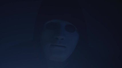 threatening look of the man with white mask and hoodie. anonymous hacker sending threatening message