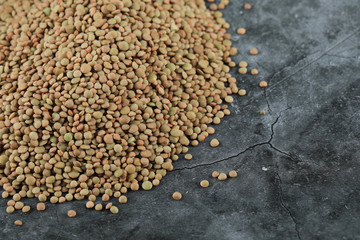 Green fresh and healthy lentil on the left corner of the blue background