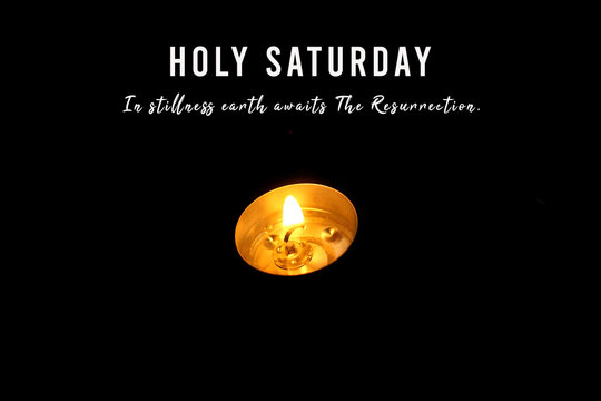 Wall Mural -  - Holy Saturday concept with Christian inspirational quote - In stillness earth awaits the resurrection. On black background with one single candle light. Card greeting and cover design. Copy space.