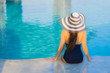 © siraphol - Portrait beautiful young asian woman relax around swimming pool in hotel resort