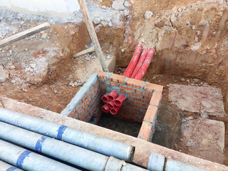 Utility services manhole under construction at the construction site. In-situ construction by workers based on infrastructure engineer design.