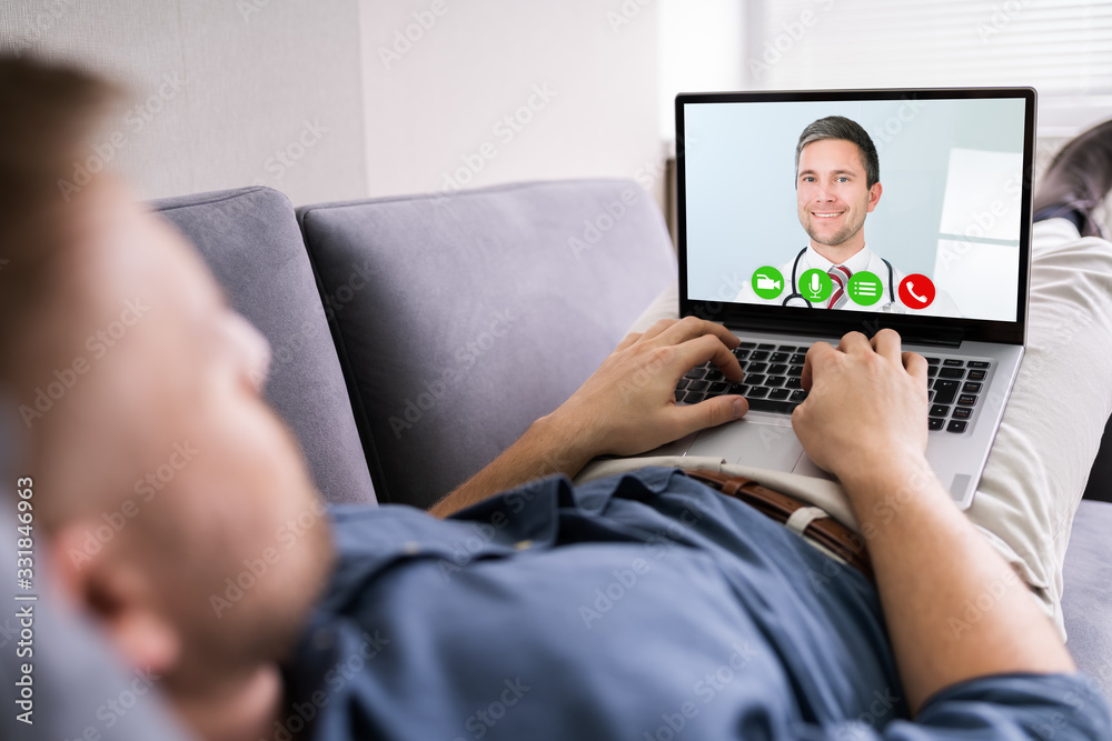 Man Videoconferencing With Doctor On Laptop - obrazy, fototapety, plakaty 