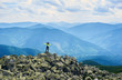 © anatoliy_gleb - Back view woman opening her arms, standing on top of cliff with powerful view mountain valley. Female tourist in bright jacket with long hair is enjoying the scenery at cloudy day.