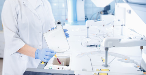 Wall Mural - bioengineer downloads blood samples for dna analysis and human cloning