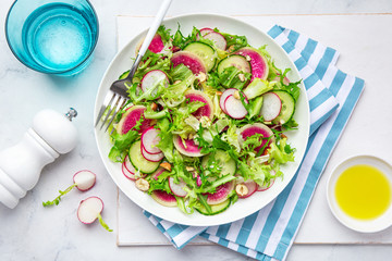 Canvas Print - Fresh vegan watermelon radish and  cucumber salad on white plate