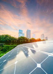 Wall Mural - solar panel photovoltaic installation with urban landscape landmarks, alternative electricity source