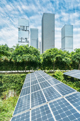 Wall Mural - solar panel photovoltaic installation with urban landscape landmarks, alternative electricity source