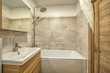 Small beige tile bathroom with bath tube