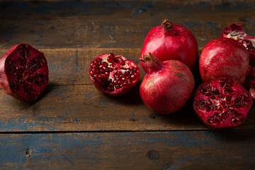 Wall Mural - Red Ripe pomegranates on wooden table