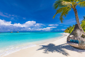 Tropical beach background as summer landscape with beach swing or hammock and white sand and calm sea for beach banner. Perfect beach scene vacation and summer holiday concept. Boost up color process