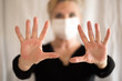 © Alexandra - Senior woman wearing mask, shows clean hands and show stop hands. Selective focus.