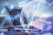 © peshkova - Double exposure of stock market graph with man working on laptop on background. Concept of financial analysis.