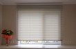 Pleated shades size XL, 50mm fold, close up on the window, white color, white background. Modern pleated blinds, luxury sun protection and window decoration.