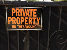 Private Property No Trespassing Sign Orange And Block On Gate