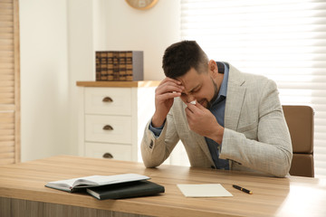 Wall Mural - Sick man sneezing in office. Influenza virus