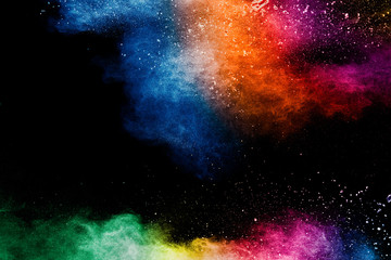colorful background of pastel powder explosion.rainbow color dust splash on black background.