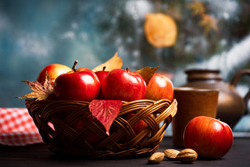 Wall Mural - Ripe red apples in wicker basket on a kitchen table