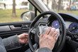 © flowertiare - Man cleaning steering wheel of a car using antivirus antibacterial wet wipe (napkin) for protect himself from bacteria and virus.