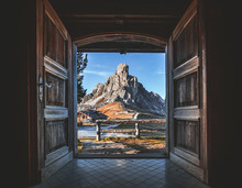 Fantastic View Over Giau Pass From Interior Of Famous Wooden Chalet. Open Doors And Beautiful View Over Dolomites In SouthTyrol, Italy