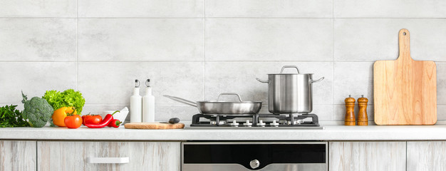 modern kitchen countertop with domestic culinary utensils on it, home healthy cooking concept banner