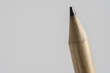 Macro photography. Close-up of an isolated wooden pencil on white background.