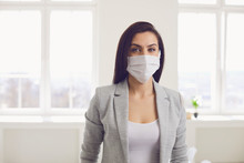Danger Of Infection Of The Virus Coronavirus Infection. Businesswoman In Medical Mask At Office