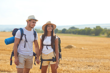 Couple hikers with backpack on hike in nature