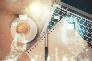 Poster - Envelop hologram drawing over computer on the desktop background. Top view. Double exposure. Technology concept.