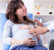 © Elnur - Pregnant woman visiting doctor for consultation