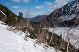 Fototapeta Góry - The snow-covered Tatras with a path on a slope of the Morskie Oko Lake valley.