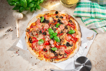 Wall Mural - Tasty homemade pizza with ham, black olives and red pepper