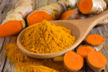 Canvas Print - Turmeric powder and fresh turmeric (curcumin) on wooden background