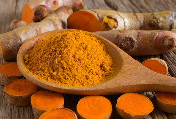 Canvas Print - Turmeric powder and fresh turmeric (curcumin) on wooden background,Used for cooking.