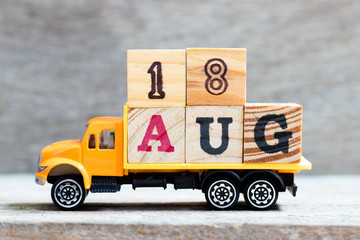 Sticker - Truck hold letter block in word 18aug on wood background (Concept for date 18 month August)