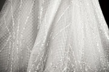  Close up of a wedding dress or bridal gown which is the dress worn by the bride during a wedding ceremony.