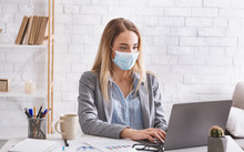 Remote Work During Epidemic. Woman Works In Protective Mask
