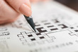 Senior woman completing crossword at home, close up